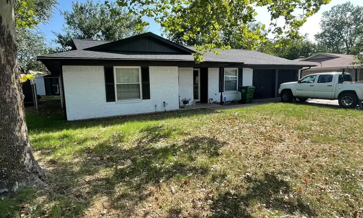 Professional roofing crew working on a residential roof in Rapho